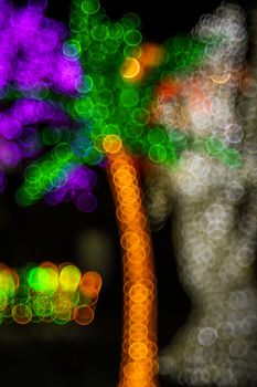 Festive abstract background with bubble bokeh defocused lights. Majestic palm tree of lights. Fantastic forest. Copy space.