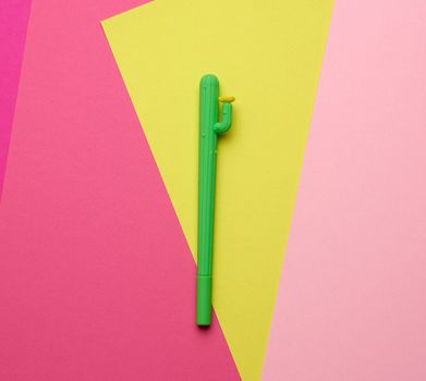 green ballpoint pen on a colored background