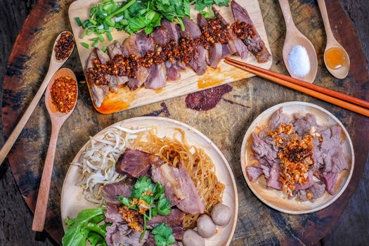Thai food Noodle soup with beef on wood background