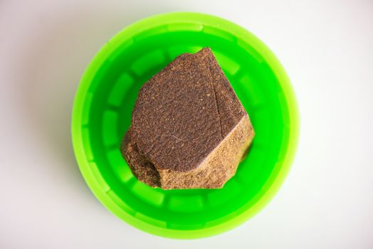 Single piece of cannabis extraction aka hashish isolated over wh
