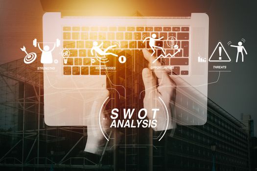 SWOT Analysis virtual diagram with Strengths, weaknesses, threats and opportunities of company.business hand using smartphone with laptop computer.