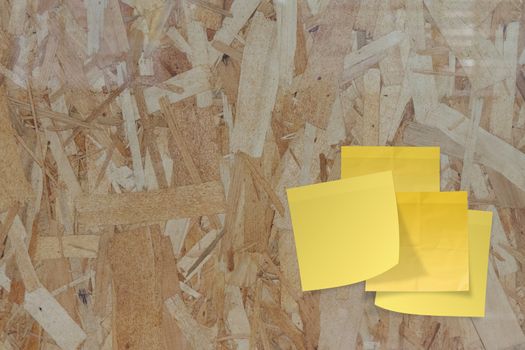 sticky paper note on recycled compressed wood chippings board 