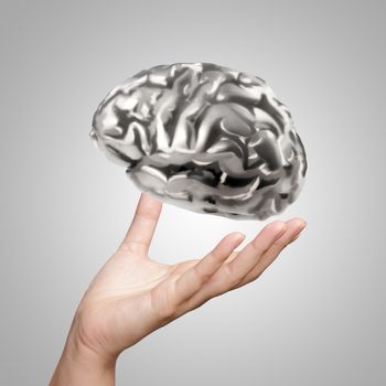businessman hand showing 3d metal human brain as concept 