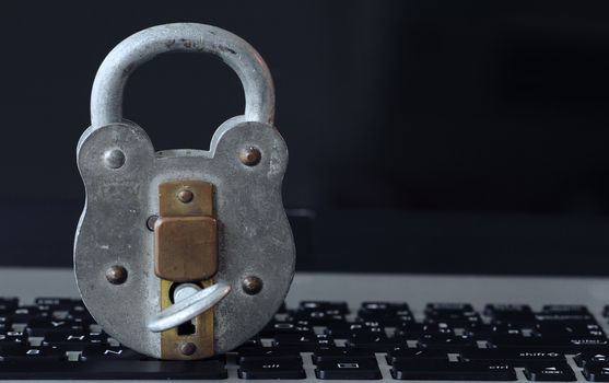 Internet security concept-old  padlock and key on laptop compute