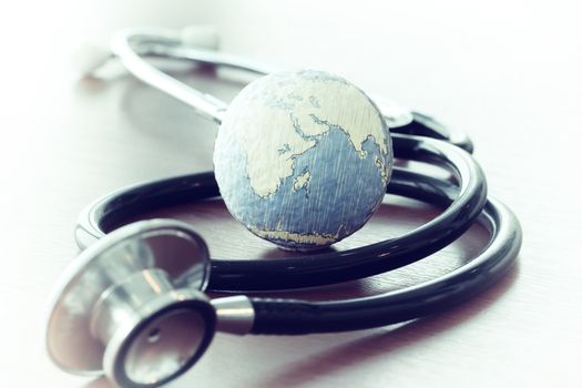Studio macro of a stethoscope and texture globe with shallow DOF