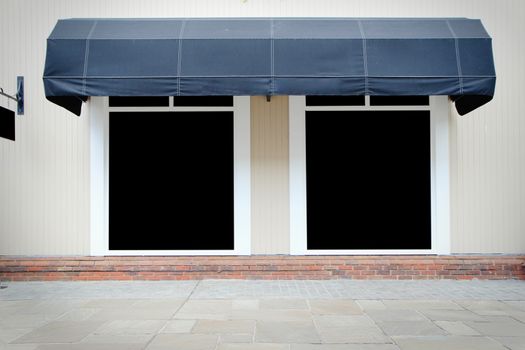 Shopfront vintage store front with canvas awnings and blank disp