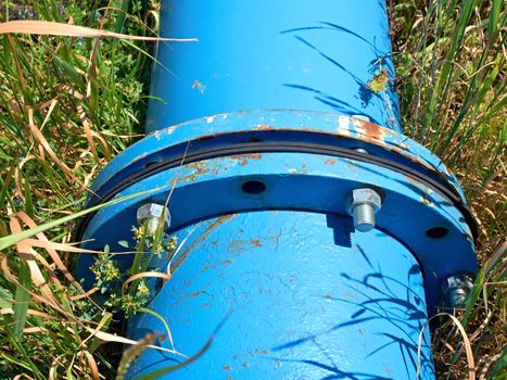 Repaired  water pipes with blue flanges and screws 