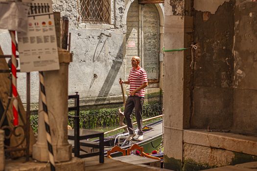 Gondolier in Venice canal 4
