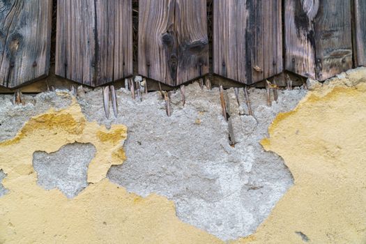 Grungy old yellow brick wall and old wood texture background with deterioration from age