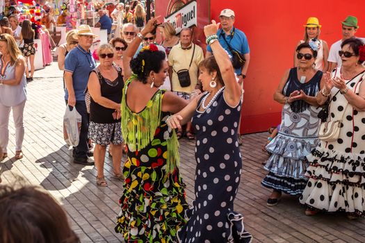 People having fun on the street at the Feria de Malaga