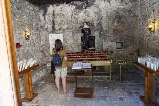 faithful who prays in the sanctuary of santa rita in rocca porena