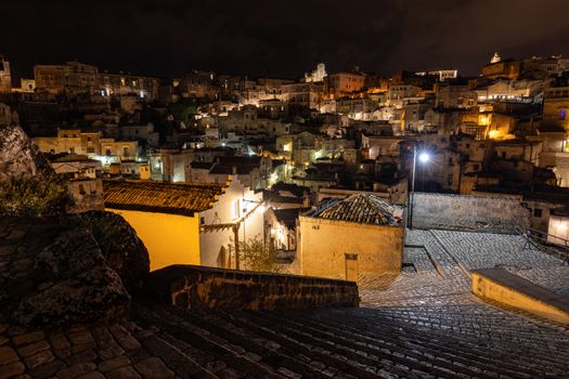 Amazing lighted buildings in ancient Sassi district by night in Matera, Basilicata. Italy