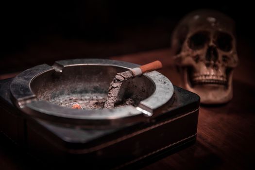 No smoking concept. Creative artwork table decoration with cigarettes. Cigarettes cause cancer and kill. still life skull and sigarette. Selective focus