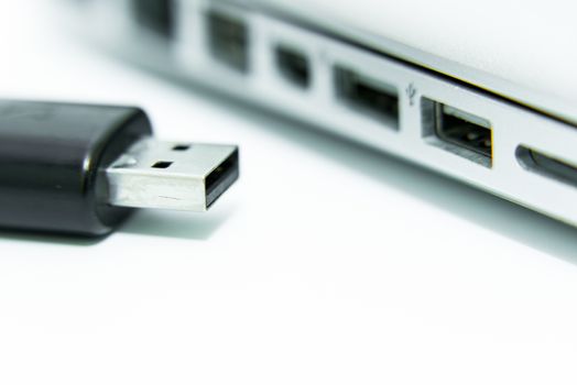 Black USB being plugged in computer laptop for copy and transfer data on isolated and white background.