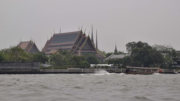 Riverside temple with a water taxi approaching