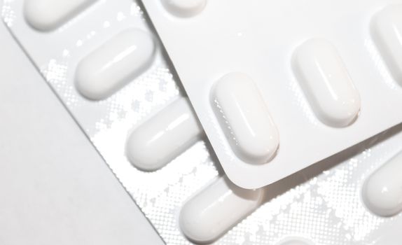 Pharmacy drugstore concept. Packs of white pills packed in blist