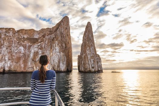 Galapagos Cruise ship tourist on boat looking at Kicker Rock nature landscape