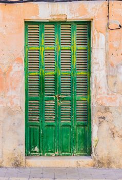 Green wooden door of mediterranean house