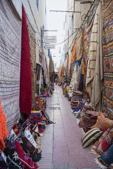 carpet lined walls of an alley in the medina 