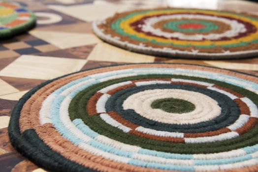 Colourful Wool table coaster on inlaid table top