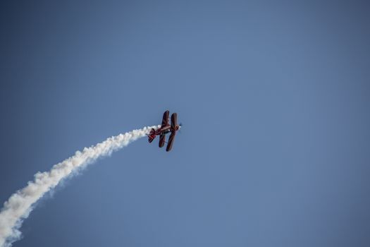 Biplane aerobatic pilot in the sky
