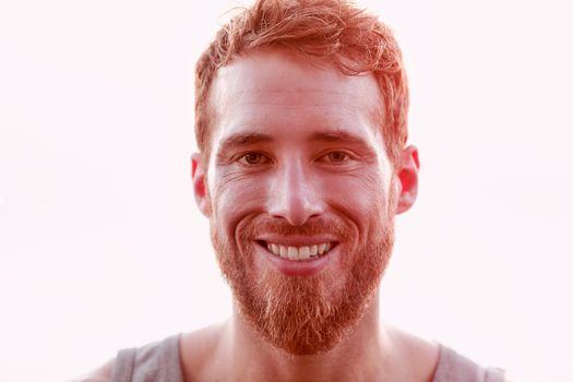 Happy young man isolated against white background. Portrait of male is with beards. Closeup of handsome man smiling.
