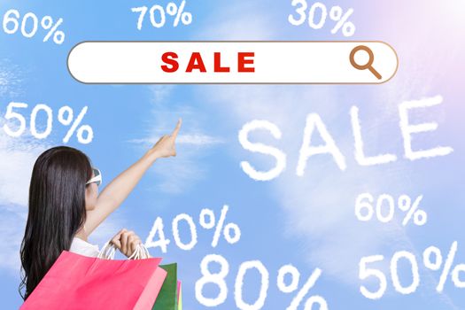 young woman holding shopping bags and internet shopping  technology concept
