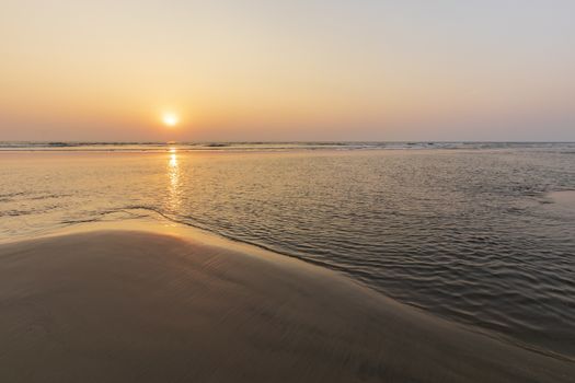 Sunset on Mandrem beach in Goa, India.