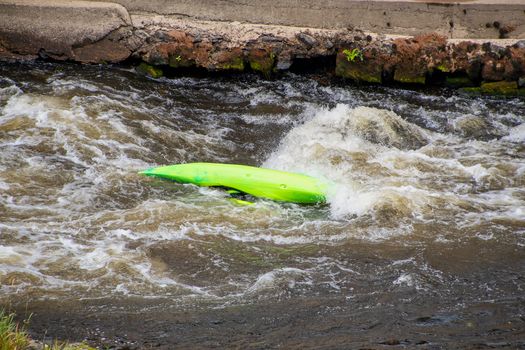 Capsized canoe in white water rapids on the river Dee