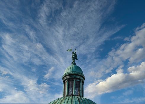 Statue on Green Cupola Against Sky