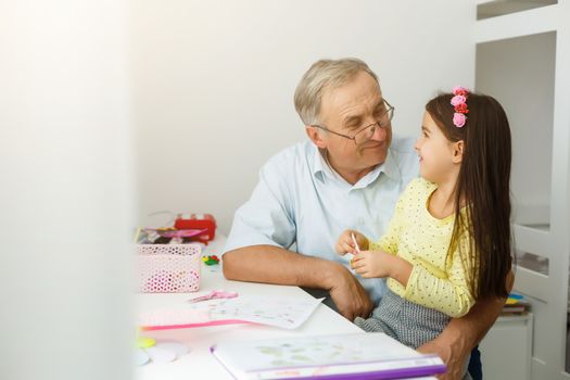 grandfather and granddaughter do her homework