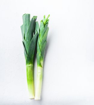 Green leek sultan onion on white table, top view.