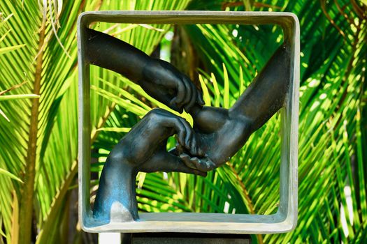 Matakana, New Zealand - Dec 2019: Sculptureum sculpture park. Bronze sculpture representing interconnected human hands; an allegory of harmony, community and friendship.