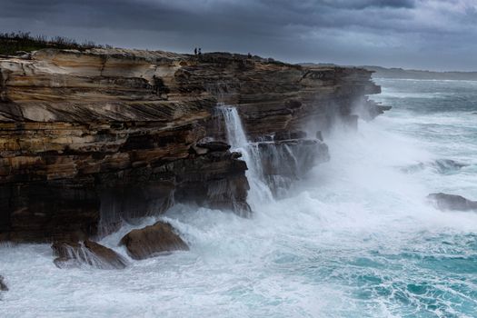 Large swells batter the cliffs of Sydney