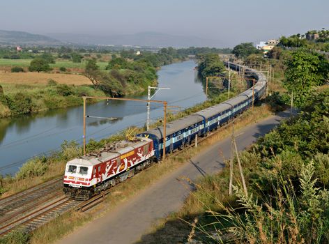Amul Milk advertised locomotive with Indore express running parallel to a river in through Kamshet, pune, India.