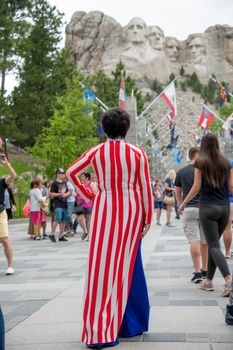 Back view of woman dressed in US colors at Mount Rushmore Nation