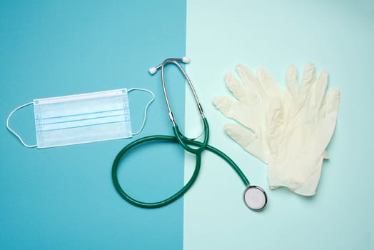 white latex gloves and disposable masks on a blue background