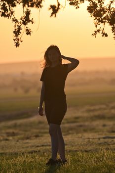 Young woman silhouette at sunset