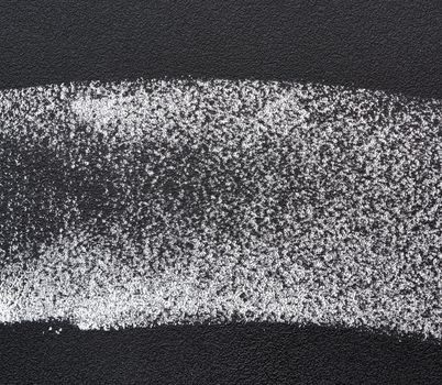 white chalk sample on a black chalk board