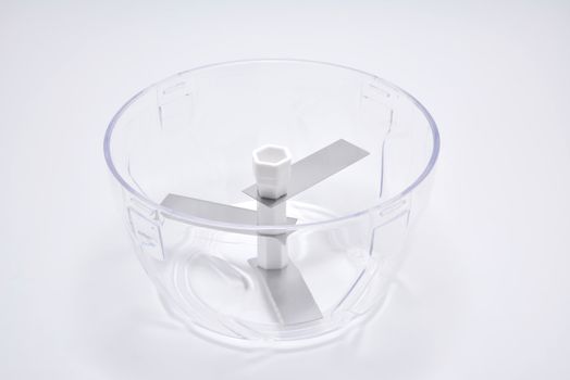 Clear plastic bowl with chopping blades and lid
