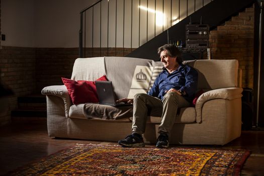 Man sitted on sofa using his laptop 3