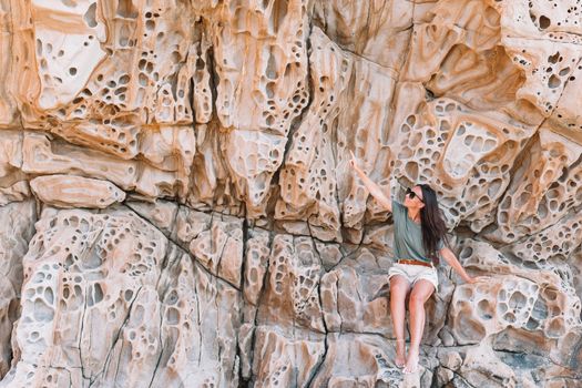 Cheese rocks from quartzite sandstone on Balck Sea in Crimea. Tourist girl in mountains