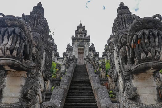 Stone ladders in beautiful Pura Lempuyang Luhur temple. Summer landscape with stairs to temple. Paduraksa portals marking entrance to middle sanctum jaba tengah of Pura Penataran Agung, Bali