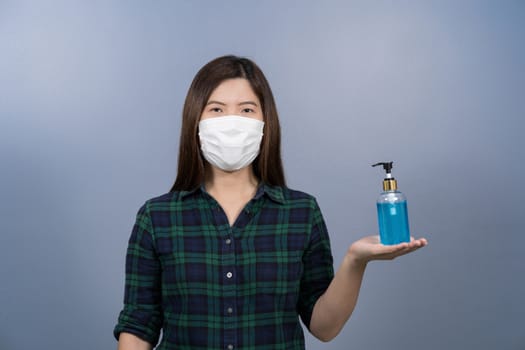 Portrait of asian female wearing face surgical mask and presenti