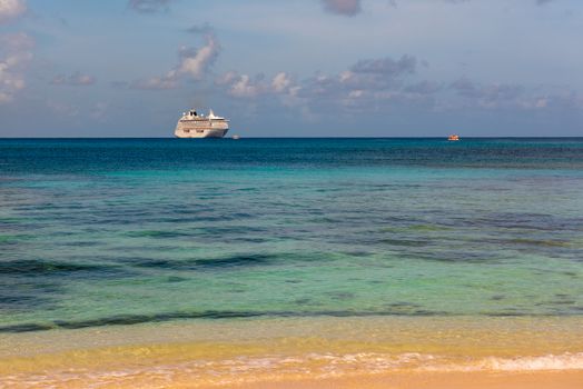 Fiji, South Pacific -- February 7, 2016. A cruise ship and tender boats are off shore close to a Fijian beach.