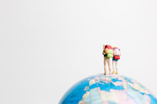 Miniature people figure  standing on the globe world map