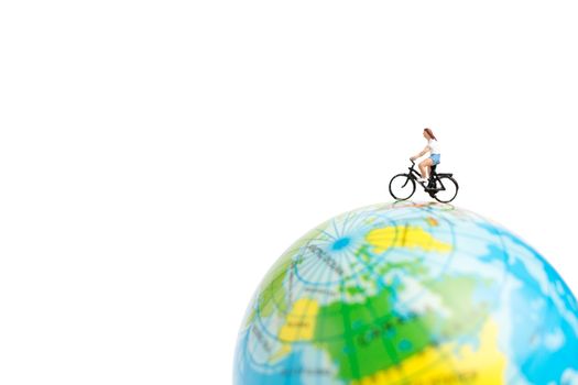 Miniature people travelers with bicycle on The globe 
