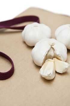 Garlic with separated pieces on wooden chopping board
