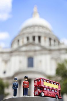 Figurines of London officers and double-decker bus with St. Paul's Cathedral in background