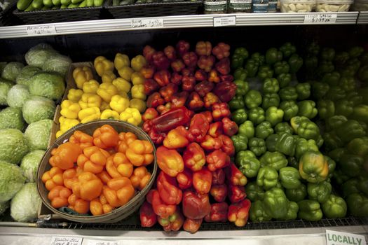 Multicolored bell peppers on display in produce market